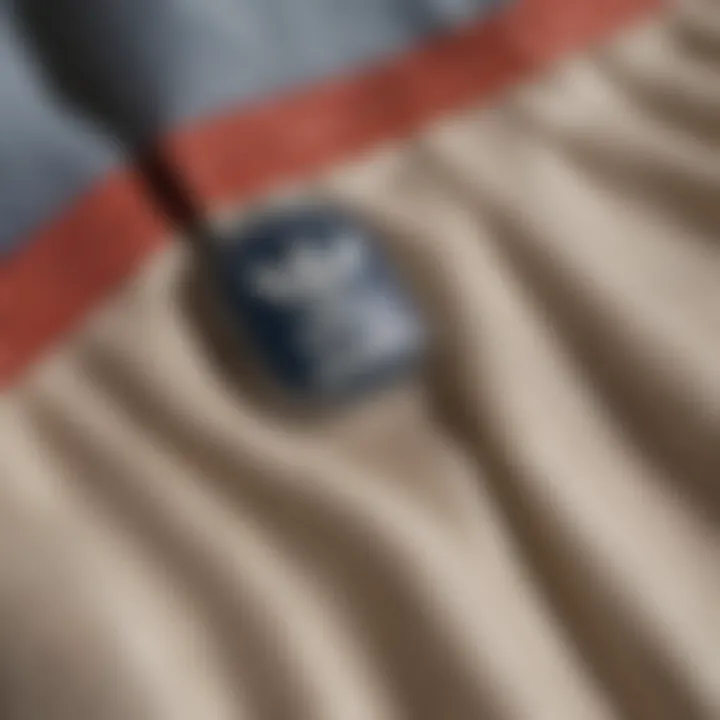 Close-up of fabric and design details of Adidas button-up pants