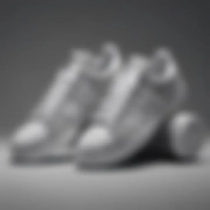 A collection of gray and white Adidas shoes arranged artistically.