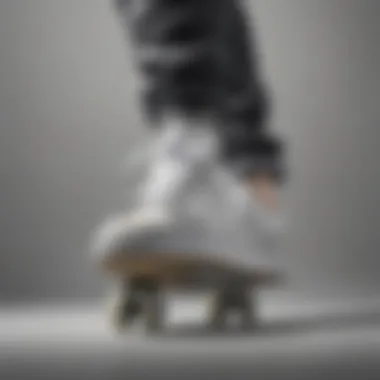 A skateboarder wearing gray and white Adidas shoes performing a trick.