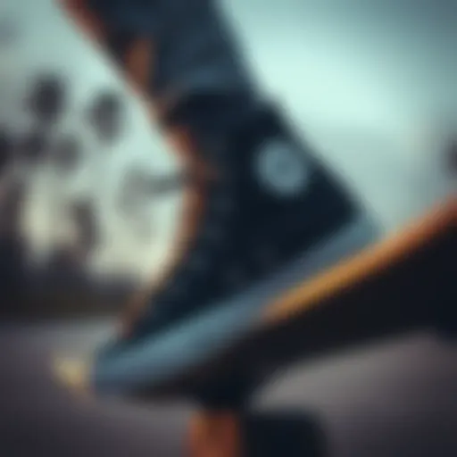 A pair of solid black Converse high tops on a skateboard