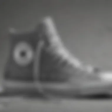 Close-up of grey Converse high tops showcasing design details