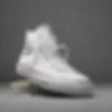 Elegant display of Converse all white sneakers on a skateboard