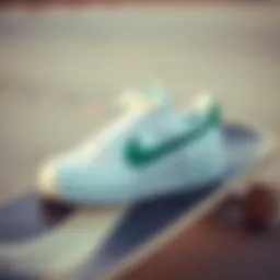 White Nike sneakers with a green swoosh on a skateboard deck