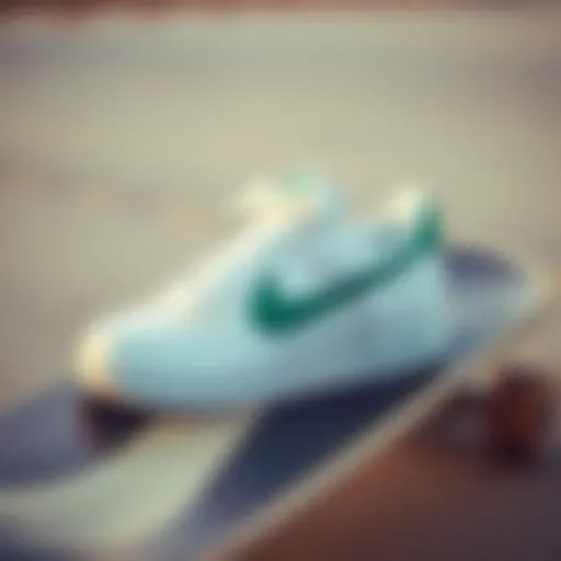 White Nike sneakers with a green swoosh on a skateboard deck