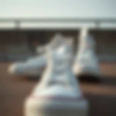 Close-up view of white tall Converse shoes on a textured surface
