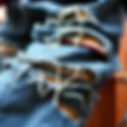 A close-up of distressed skater ripped jeans showcasing unique fraying and patchwork.