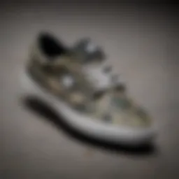 A close-up of camo DC shoes on a skateboard deck