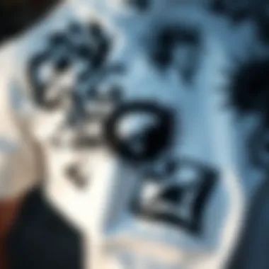 A close-up of a white black graphic tee featuring intricate designs