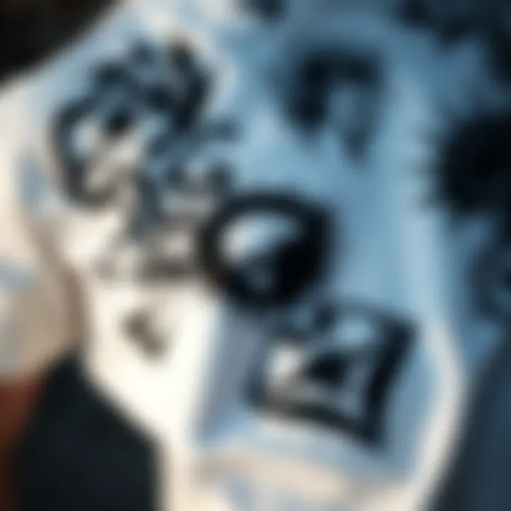 A close-up of a white black graphic tee featuring intricate designs