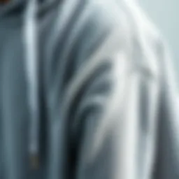 Close-up of grey sweatshirt hoodie fabric showcasing texture and quality.