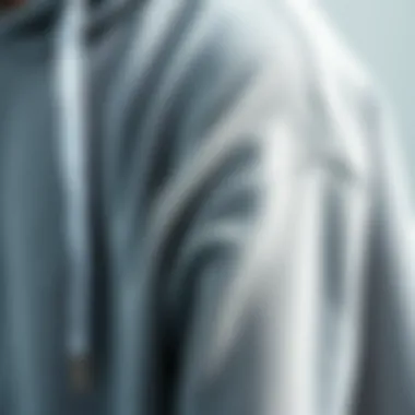 Textural Quality of the Grey Hoodie Close-up of grey sweatshirt hoodie fabric showcasing texture and quality.