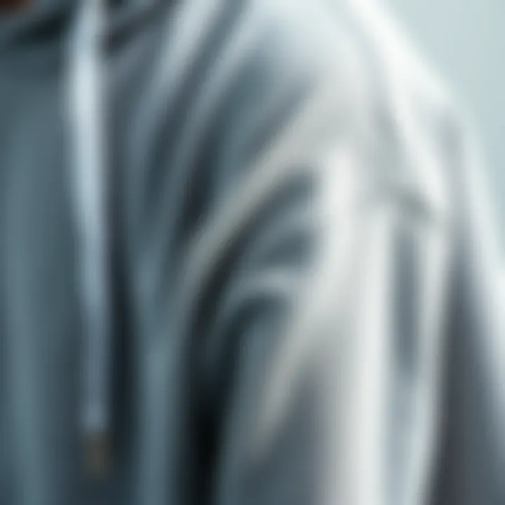 Textural Quality of the Grey Hoodie Close-up of grey sweatshirt hoodie fabric showcasing texture and quality.