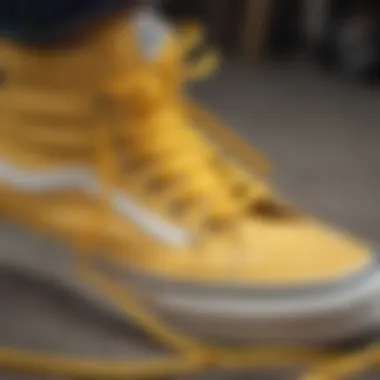 A close-up view of yellow shoelaces contrasting against a pair of classic Vans sneakers.