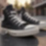 Close-up view of unisex black high top Converse on a skateboard