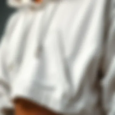 Close-up of white crop top hoodie fabric and stitching