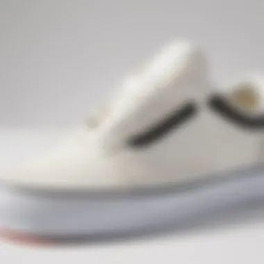 Close-up view of Vans Old Skool white shoes showcasing the iconic side stripe