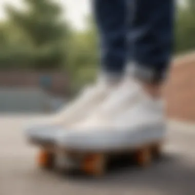 Vans Old Skool white shoes on a skateboard at a skate park