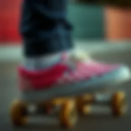 Vans pink checkered slip-ons worn on a skateboard
